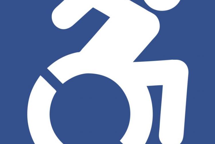 Λογότυπο με κάποιον σε αναπηρικό αμαξίδιο που δείχνει να παλεύει